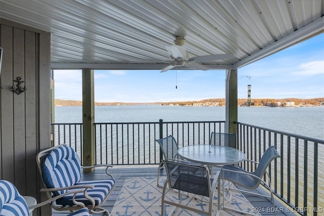 wooden deck featuring ceiling fan and a water view