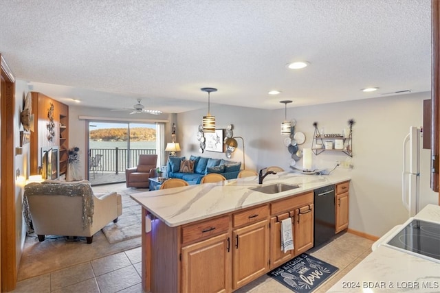 kitchen with light tile patterned floors, black dishwasher, decorative light fixtures, and sink