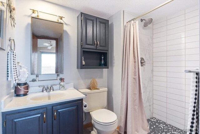 bathroom featuring a shower with curtain, toilet, a textured ceiling, and vanity