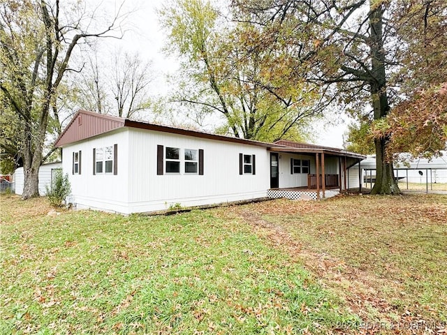 rear view of house featuring a yard