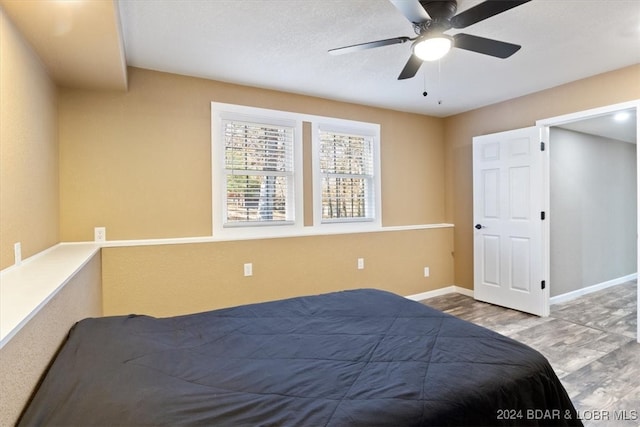 bedroom featuring hardwood / wood-style flooring and ceiling fan