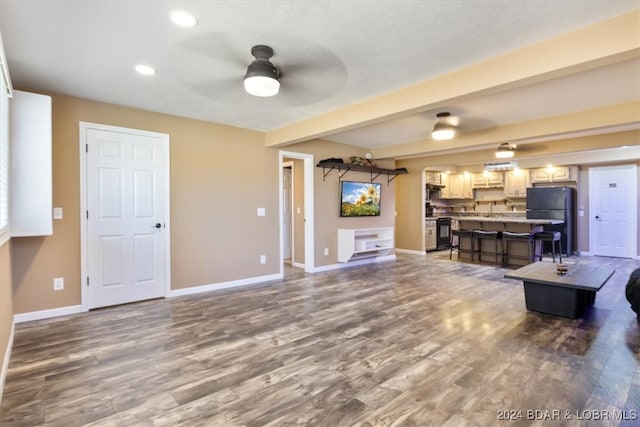 living room featuring ceiling fan and dark wood-type flooring