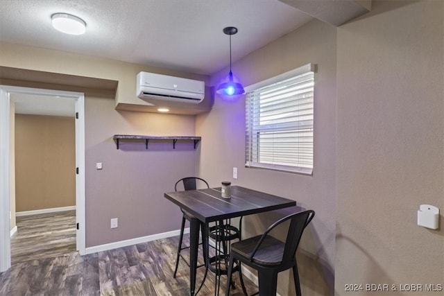 dining room with a wall mounted air conditioner and dark wood-type flooring