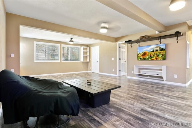 living room with beamed ceiling and wood-type flooring