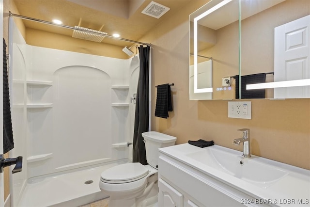 bathroom with a shower with shower curtain, vanity, and toilet