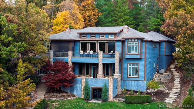 back of house featuring a balcony, cooling unit, and a sunroom