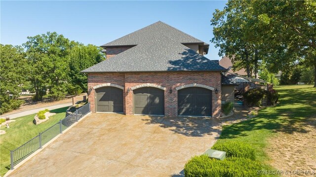 5745 Tree Leaf Ct, Osage Beach, MO 65065 - view of home's exterior featuring brick siding and a shingled roof