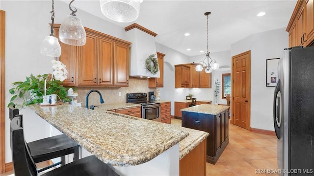 kitchen with a kitchen bar, a center island, stainless steel appliances, kitchen peninsula, and hanging light fixtures