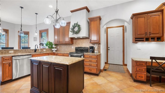 kitchen featuring hanging light fixtures, a kitchen island, sink, custom range hood, and appliances with stainless steel finishes