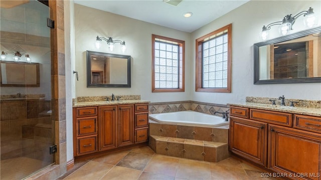 bathroom featuring tile patterned floors, separate shower and tub, and vanity