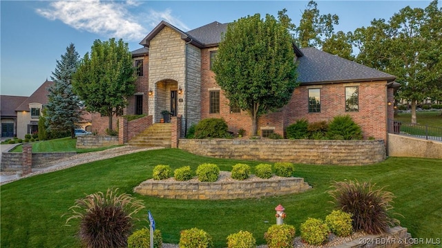 5745 Tree Leaf Ct, Osage Beach, MO 65065 - view of front facade featuring stone siding and brick siding