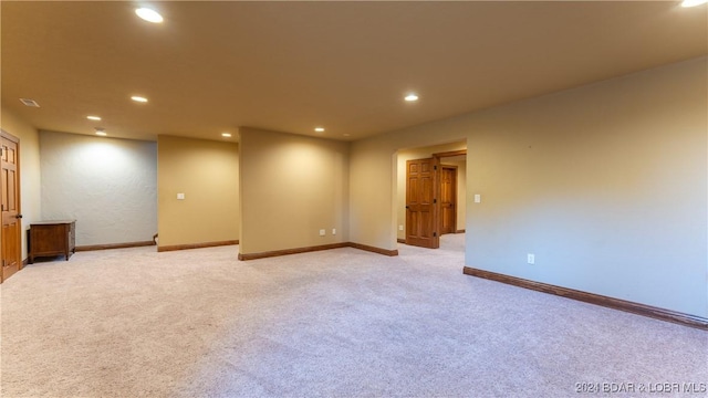 spare room with light colored carpet