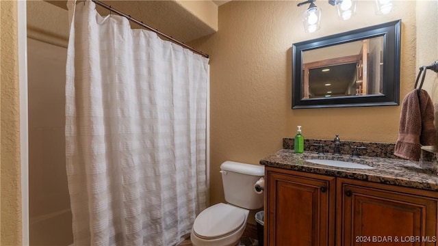 bathroom with toilet, curtained shower, and vanity