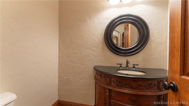 bathroom with toilet and vanity