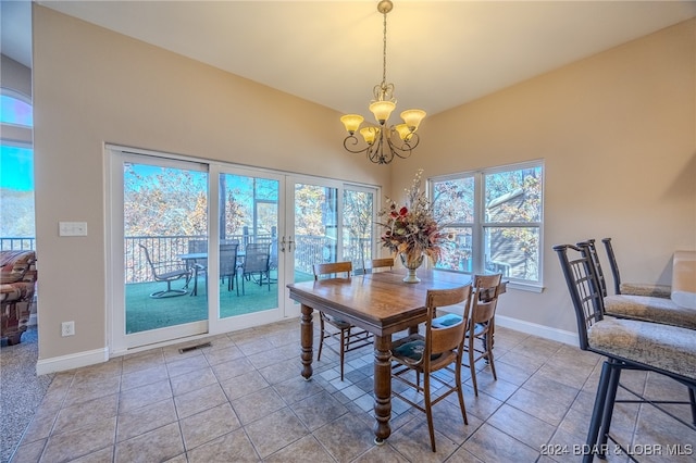 dining room with light tile patterned floors and a chandelier