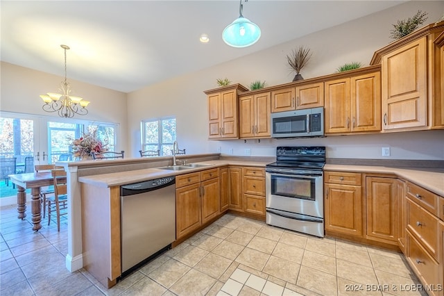 kitchen with hanging light fixtures, light tile patterned floors, stainless steel appliances, and an inviting chandelier