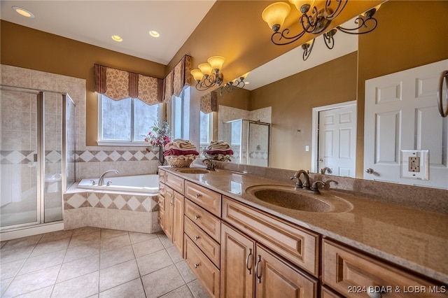 bathroom with tile patterned flooring, vanity, separate shower and tub, and an inviting chandelier