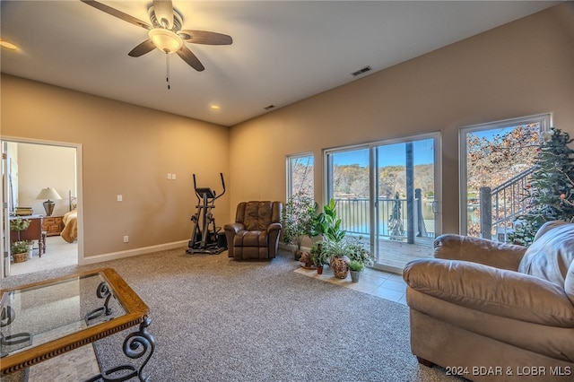 carpeted living room featuring ceiling fan