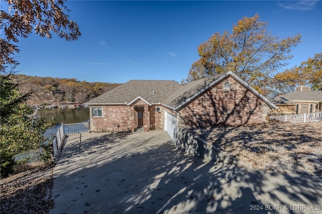 view of front of home featuring a water view and a garage