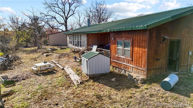 view of side of home with a shed