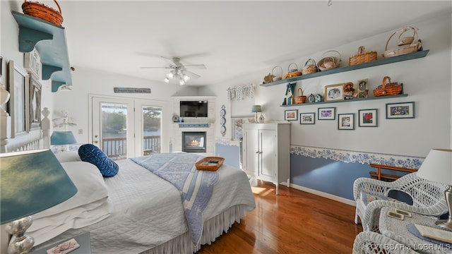 bedroom featuring access to exterior, hardwood / wood-style flooring, and ceiling fan