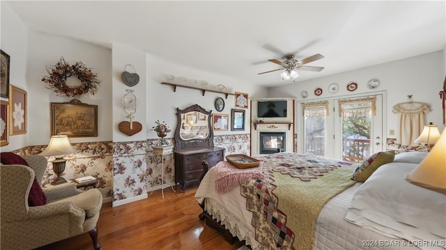 bedroom with hardwood / wood-style flooring, ceiling fan, and access to outside