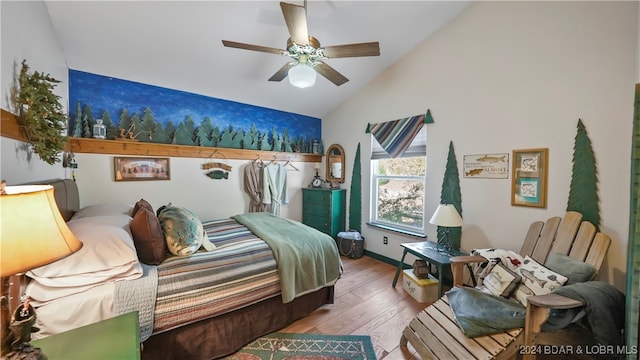 bedroom with light hardwood / wood-style flooring, ceiling fan, and lofted ceiling