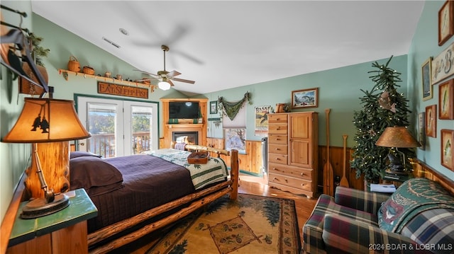 bedroom with hardwood / wood-style flooring, ceiling fan, and lofted ceiling