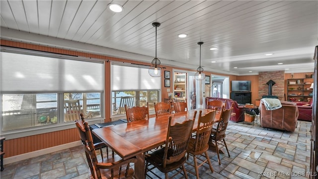 dining area featuring a wealth of natural light and wood walls