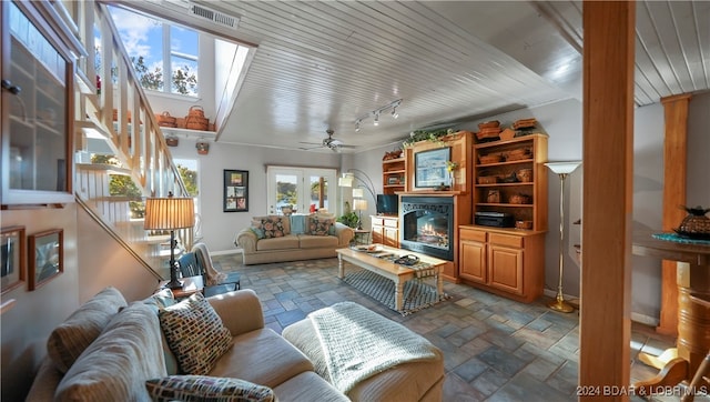 living room featuring ceiling fan and french doors