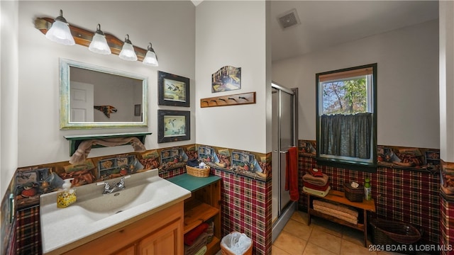 bathroom with tile patterned flooring, vanity, and an enclosed shower