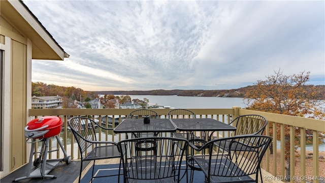 balcony featuring a deck with water view