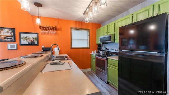 2500 Bay Point Ln Unit 645, Osage Beach, MO 65065 - kitchen with appliances with stainless steel finishes, a sink, green cabinetry, and light countertops