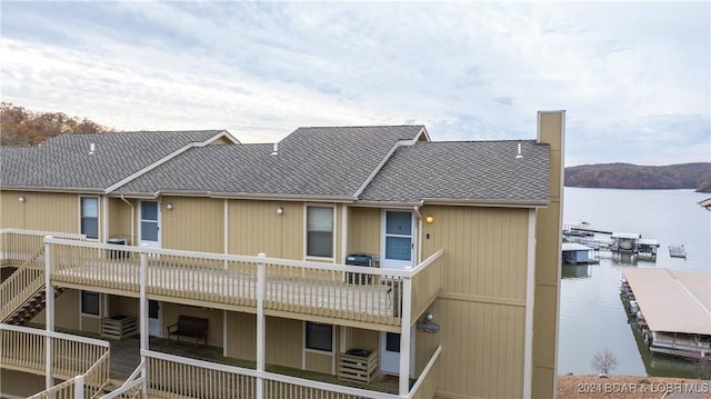 2500 Bay Point Ln Unit 645, Osage Beach, MO 65065 - rear view of house with a water view, a shingled roof, and central AC