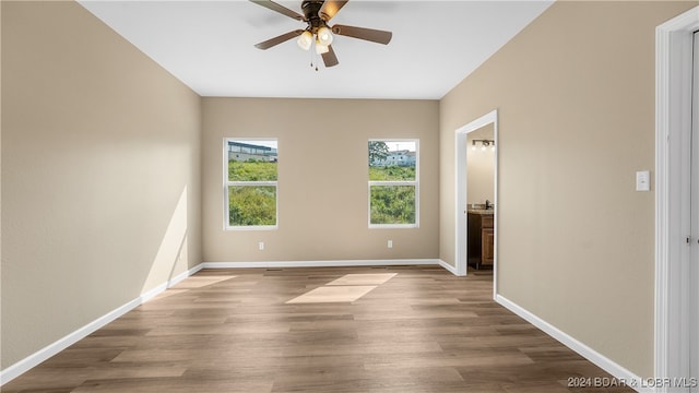 unfurnished room featuring hardwood / wood-style flooring and ceiling fan