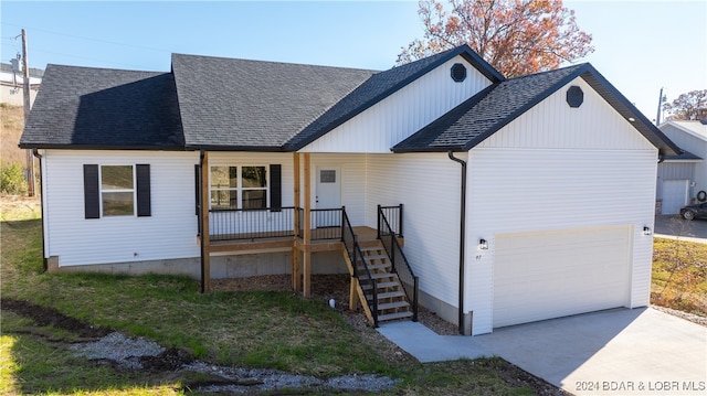 view of front facade with a porch and a garage