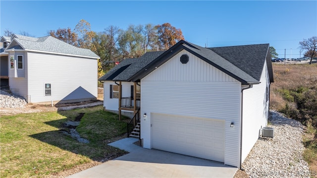 view of side of property featuring a yard and a garage