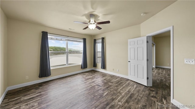 unfurnished bedroom featuring baseboards, ceiling fan, and dark wood-style flooring