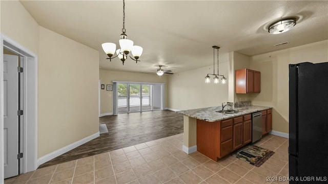 kitchen with open floor plan, light tile patterned floors, stainless steel dishwasher, freestanding refrigerator, and a sink