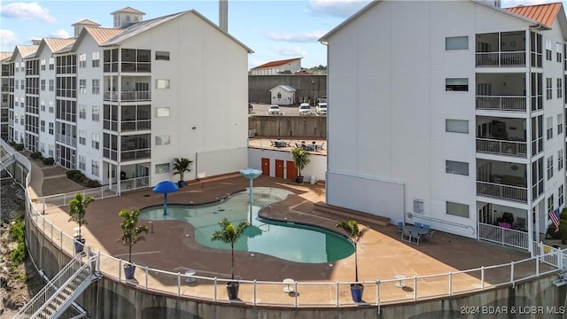 pool featuring a patio and fence