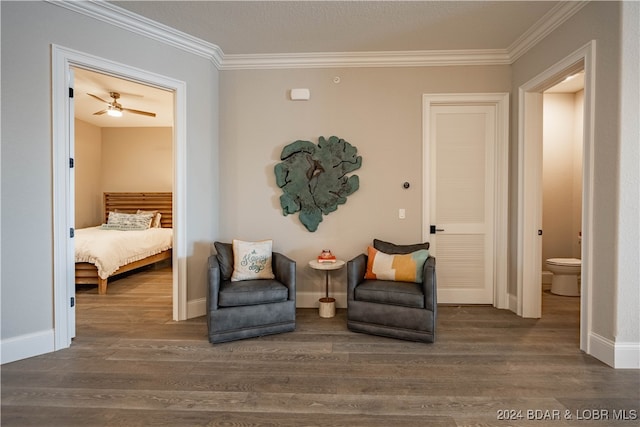 living area featuring crown molding, ceiling fan, and dark wood-type flooring