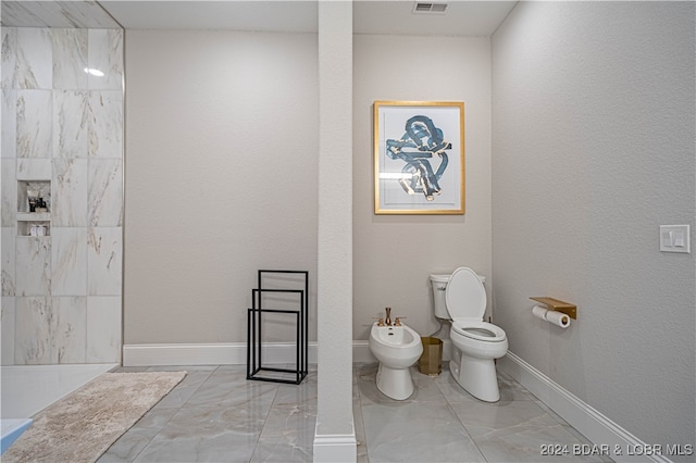 bathroom with toilet and a bidet