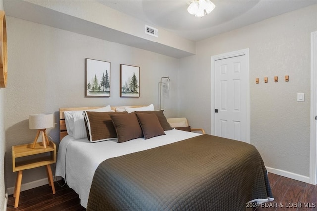 bedroom with dark wood-type flooring