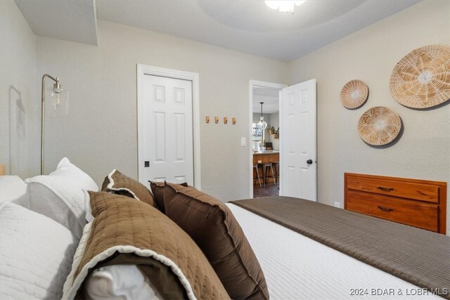 bedroom with a notable chandelier