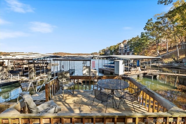 wooden terrace with a dock and a water view