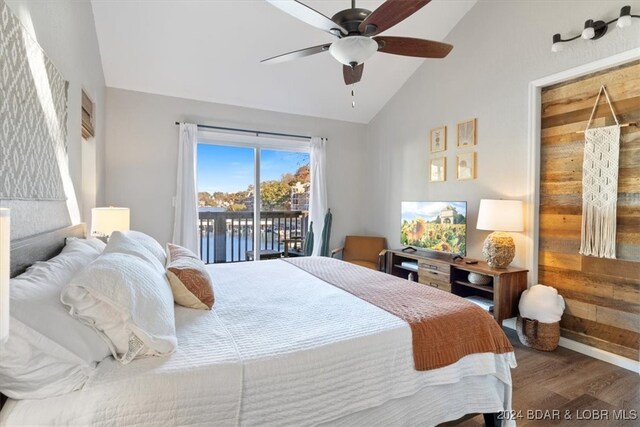 bedroom featuring access to outside, ceiling fan, wood-type flooring, and lofted ceiling