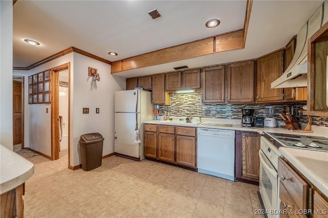 kitchen featuring white appliances, baseboards, light countertops, ornamental molding, and backsplash