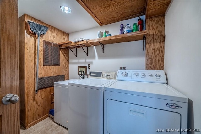 laundry area featuring laundry area, light tile patterned floors, and separate washer and dryer