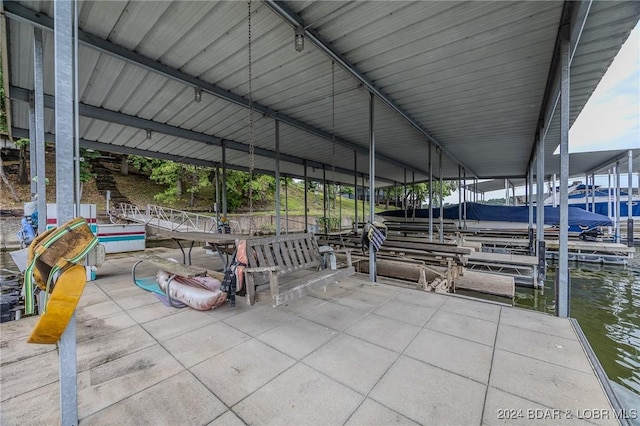 dock area with a water view and boat lift