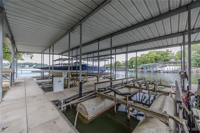 dock area with a water view and boat lift